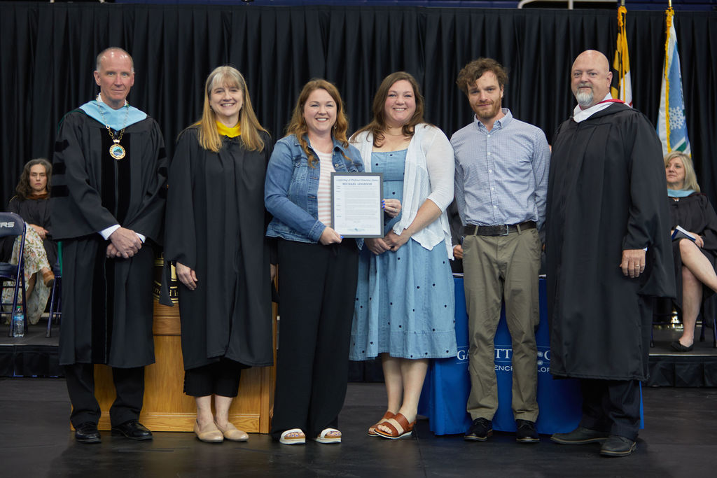 family of michael logsdon accepting emertius award